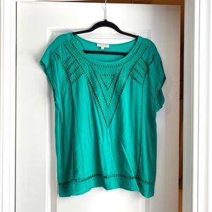 Green cap sleeve blouse with eyelet detail.
